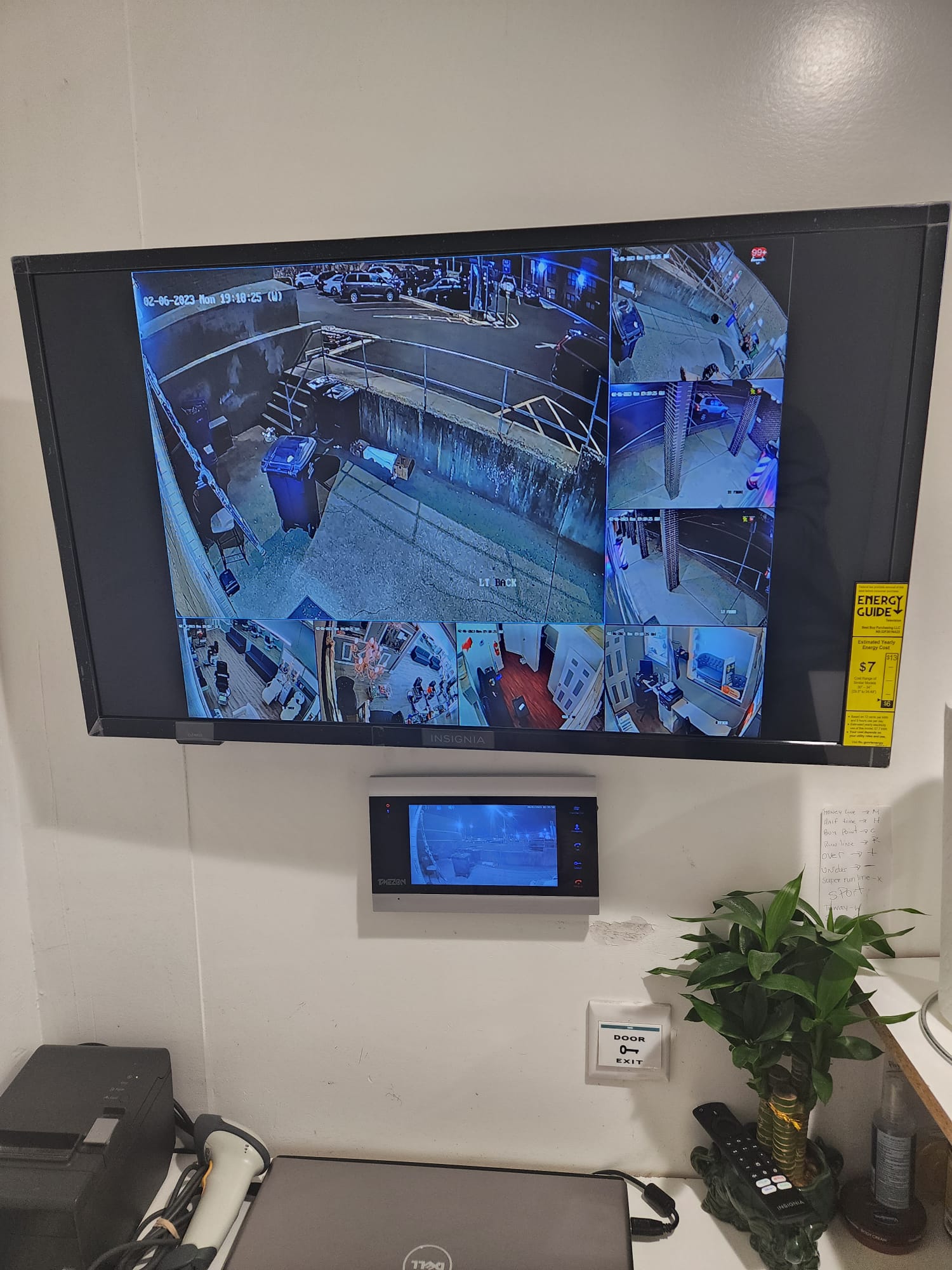 Commercial access control installation with a CCTV monitor, intercom terminal, and door exit button