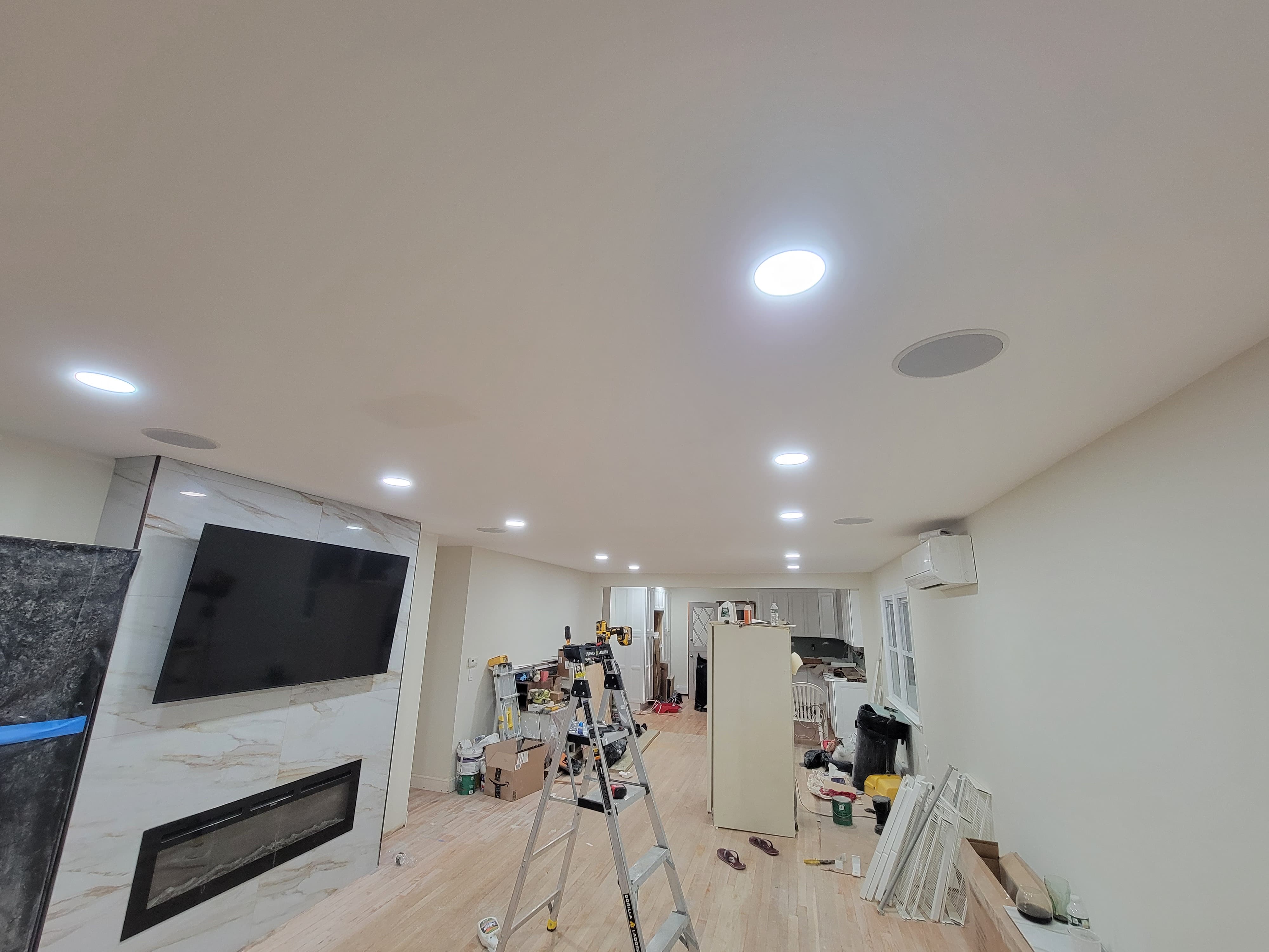 Flush-mounted ceiling speakers installed throughout a residential living space